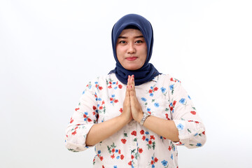 Asian veiled woman standing while showing welcoming or greeting hand gesture. Isolated on white