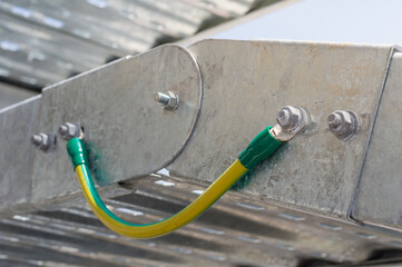 Electrical Wire way and Cable Ladder install at outdoor Area.Ground bonding cable between two Wire way .Ground Bonding for cable tray.Cable connected to electrical ground bar for safety