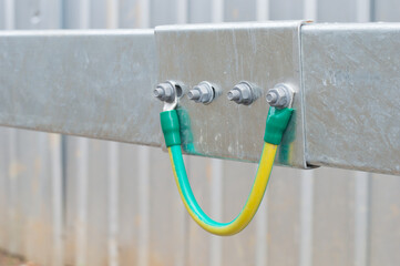 Electrical Wire way and Cable Ladder install at outdoor Area.Ground bonding cable between two Wire way .Ground Bonding for cable tray.Cable connected to electrical ground bar for safety