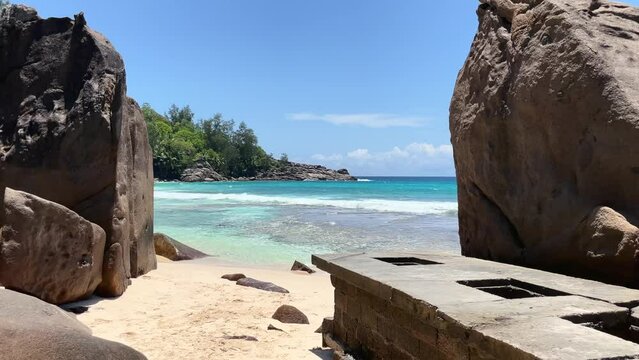 Mahe Seychelles white sandy beach between huge granite rocks, turqoise sea water