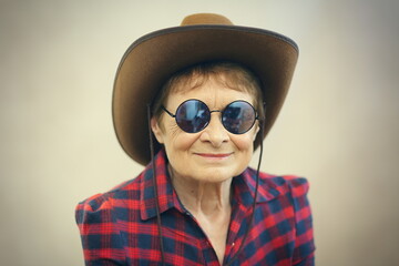older woman wearing glasses and cowboy hat