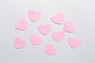 Felt hearts on color background, top view
