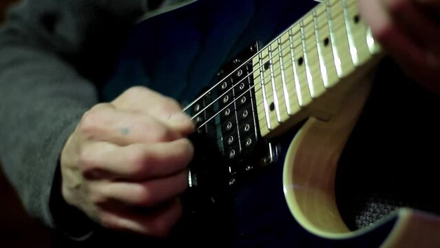 man playing electric guitar with pick making music stock video stock footage