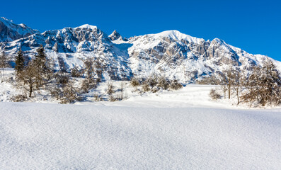 Beautiful winter mountain snow-covered landscape on sunny day. Andalo village, Adamello Brenta Natural Park, Trentino Alto Adige, northern Italy, Europe