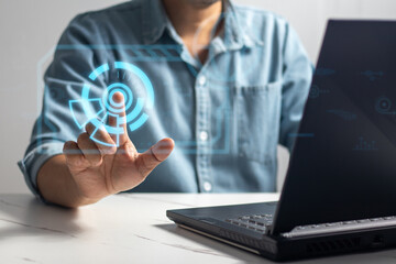 Man sitting at table touching complex circular diagram on virtual