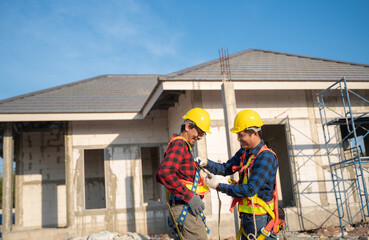 An engineering team prepares a safety suit before starting construction work. Construction workers rehearse and prepare safety clothes before starting work.