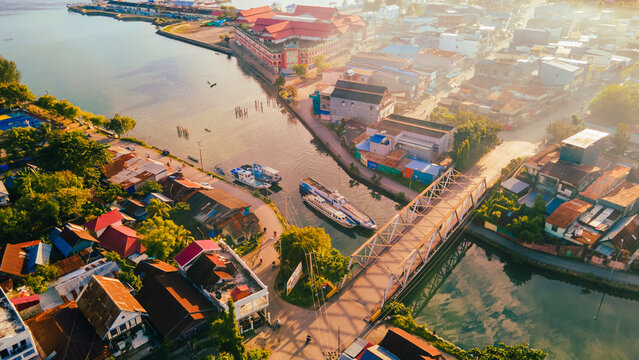 Aerial photo with top view of the suburbs between the sea and the morning sunshine