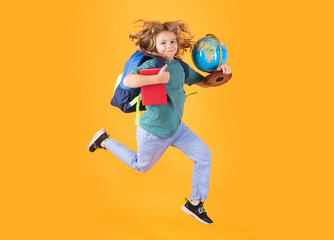 Shool kid jump with school bag and globe. School boy in school uniform with backpack jumping on...