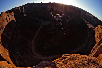 A man base jumping off the Tombstone cliff outside of Moab, Utah, USA.