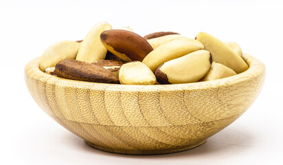 bowl with brazilian chestnut, on white insulator background. Brazil nuts known as 