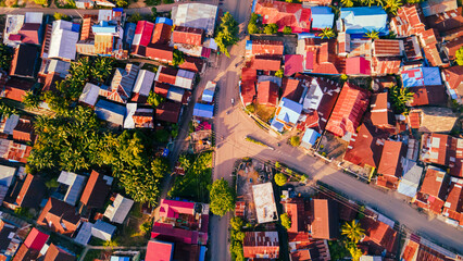 Fototapeta na wymiar Aerial photo of the suburbs between green parks and morning sunshine