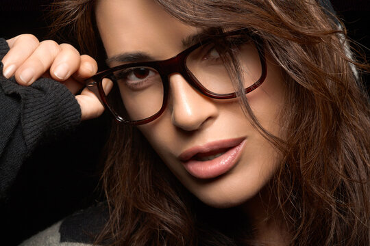 Gorgeous Woman Face with Eyeglasses. Cool Trendy Eyewear Portrait on Black Background