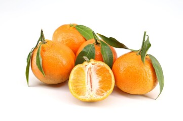 Clementines with leaves on white background.