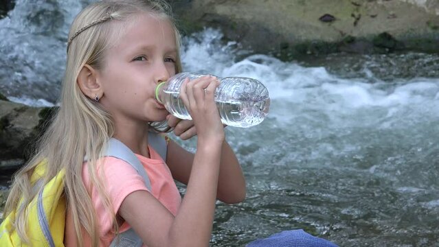 Kid Drinking Water by River, Child in Camping in Mountains, Girl Drink Fresh Spring Water, Outdoor In Nature, Children Healthcare