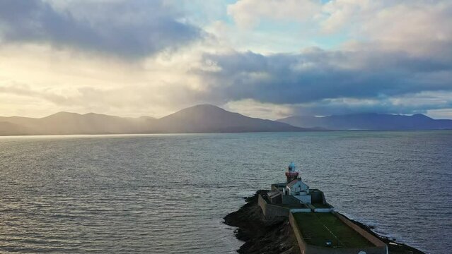 Aerial panorama view of the historic Fenit Lighthouse in Tralee Bay, beautiful clouds, sunset. High quality 4k footage