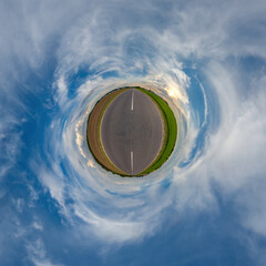 tiny planet in blue overcast sky with beautiful clouds with transformation of spherical panorama...