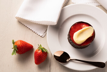 Aerial view of strawberry and chocolate tartlet on clear background. Pastry concept.
