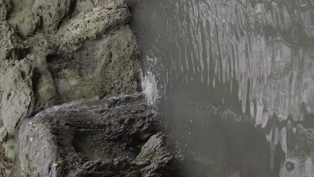 water flowing into the water small waterfall in a park portrait orientation  | Park, 4k ProRes 10bit handheld