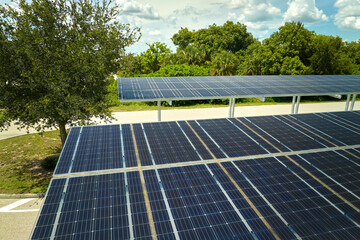 Aerial view of solar panels installed as shade roof over parking lot for parked cars for effective generation of clean electricity. Photovoltaic technology integrated in urban infrastructure