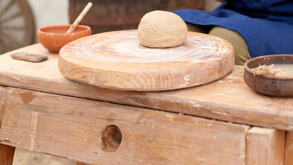 clay lump on potter's wheel ready for potter to turn it into ware