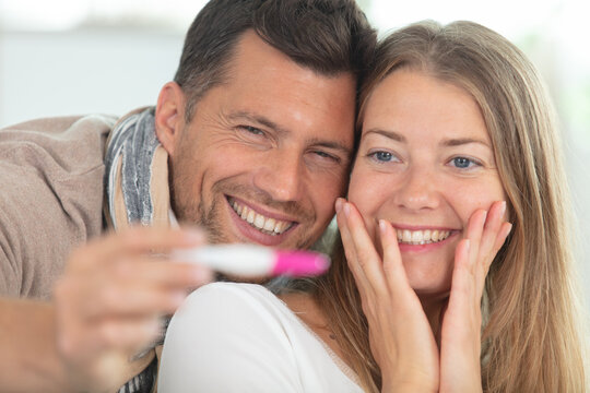 happy couple with pregnancy news