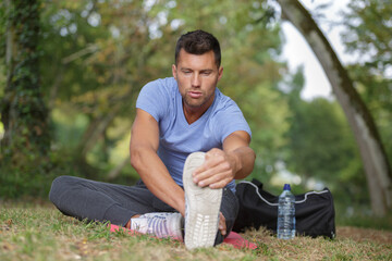 fit man stretching legs outdoors