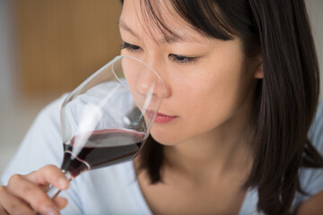 young woman smells the wine