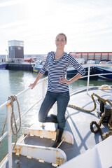 attractive woman standing on a fishing boat