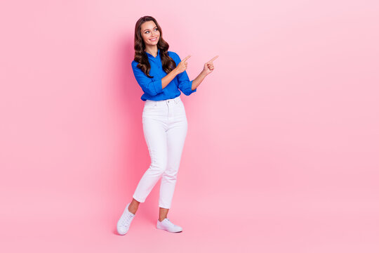Full body size photo of hr manager lady wear blue shirt pants interested indicate fingers empty space vacancy isolated on pink color background