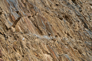 The texture of rocks in the sun. The stone structure of the rock