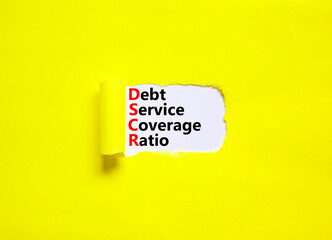 DSCR debt service coverage ratio symbol. Concept words DSCR debt service coverage ratio on white paper on beautiful yellow background. Business DSCR debt service coverage ratio concept. Copy space.