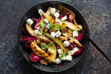 Roasted pear and chicory salad with walnuts and feta cheese