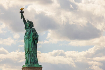 Fototapeta premium Beautiful view of Statue of Liberty against backdrop of white clouds. New York. USA.