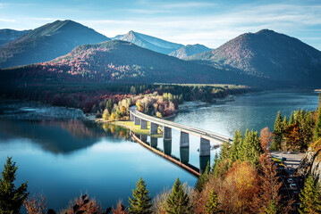 Scenic nature landscape. Sunrise on Sylvenstein lake with vivid sky. Beautiful alpine sunny view on...