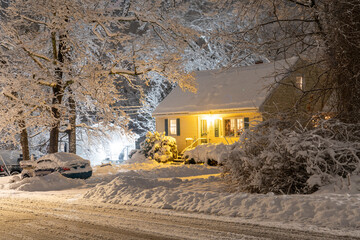  landscape of residential house at night during snow with light turn on © nd700