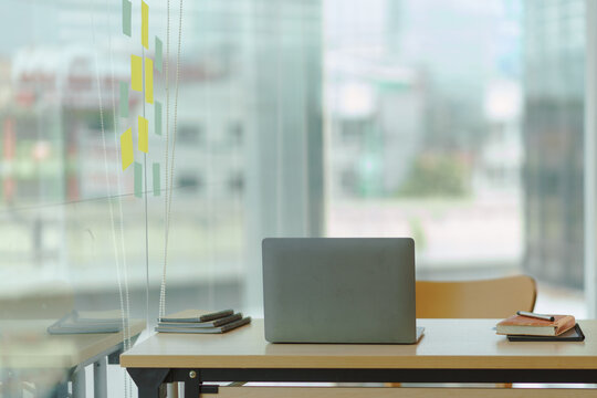 Image of a modern modern office work room with a personal computer laptop in the executive office emphasizes privacy and orderliness in the office.