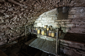 An old cellar with a shelf with a stone clamp.