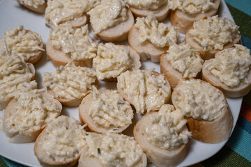 Fototapeta na wymiar Garlic canapés with cheese on a roll.
