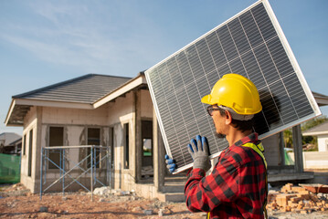 technician working on installation Solar panels and solar cells are installed on the roof of the house.