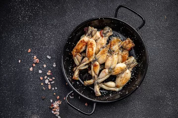 Foto op Canvas fried frog legs second course meat french food healthy meal food snack on the table copy space food background rustic top view © Alesia Berlezova