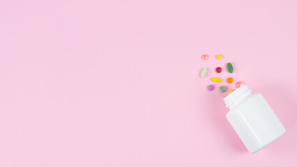 scattered pills on color background, top view. Space for text the left