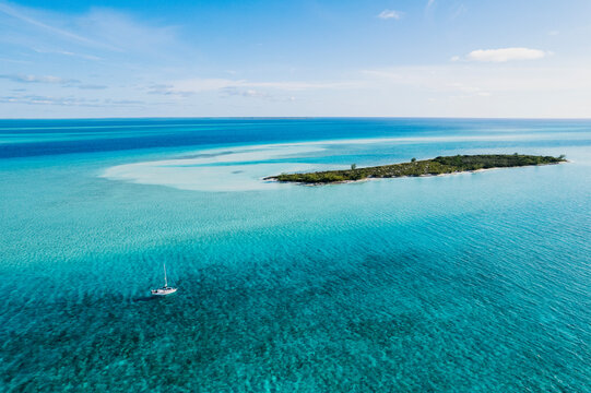 Aerial of Sailboat Next to Island in Turquoise Bahamas Water