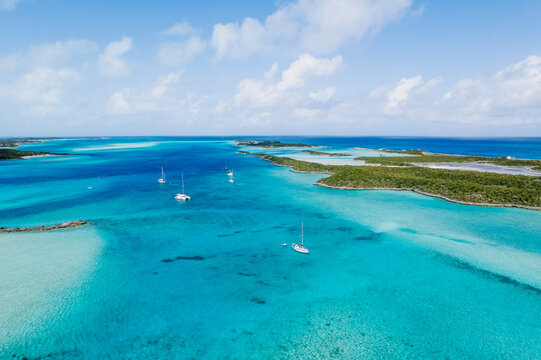 Aerial of Sailboats Anchored in Turquoise Water Between Islands