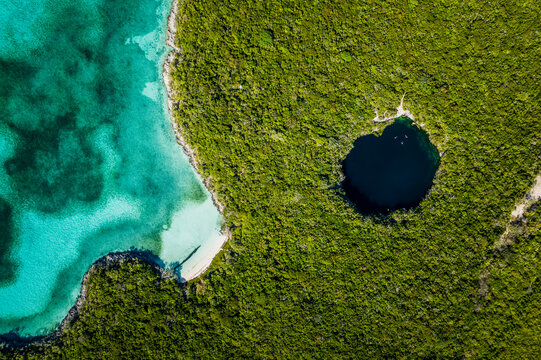 Aerial of Swimmers in Blue Hole at Hoffman Cay, Bahamas