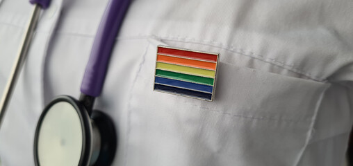 Woman doctor with lgbt flag on the pocket of clinic office