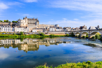 Fototapeta na wymiar Amboise, France. The walled town and Chateau of Amboise reflected in the River Loire.