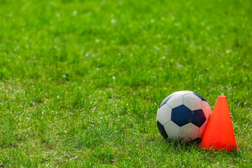 Fototapeta na wymiar Soccer ball tactics on grass field with cone for training
