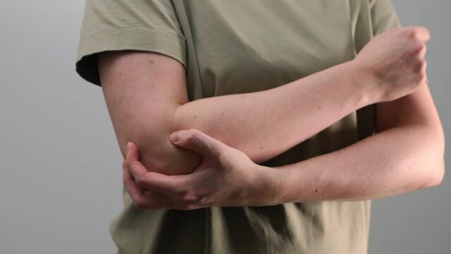 Elbow joint pain, ache. Muscle, bone injury, trauma. Hand touching hurting body part, discomfort, cramp