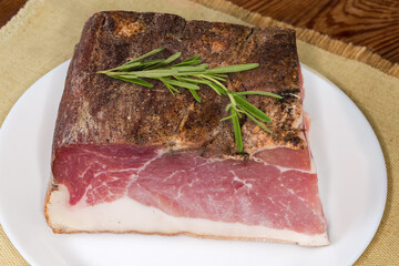 Piece of dry-cured pork belly on the dish