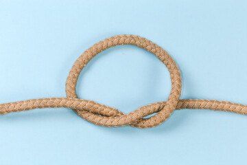 Rope knot as overhand knot on a blue background